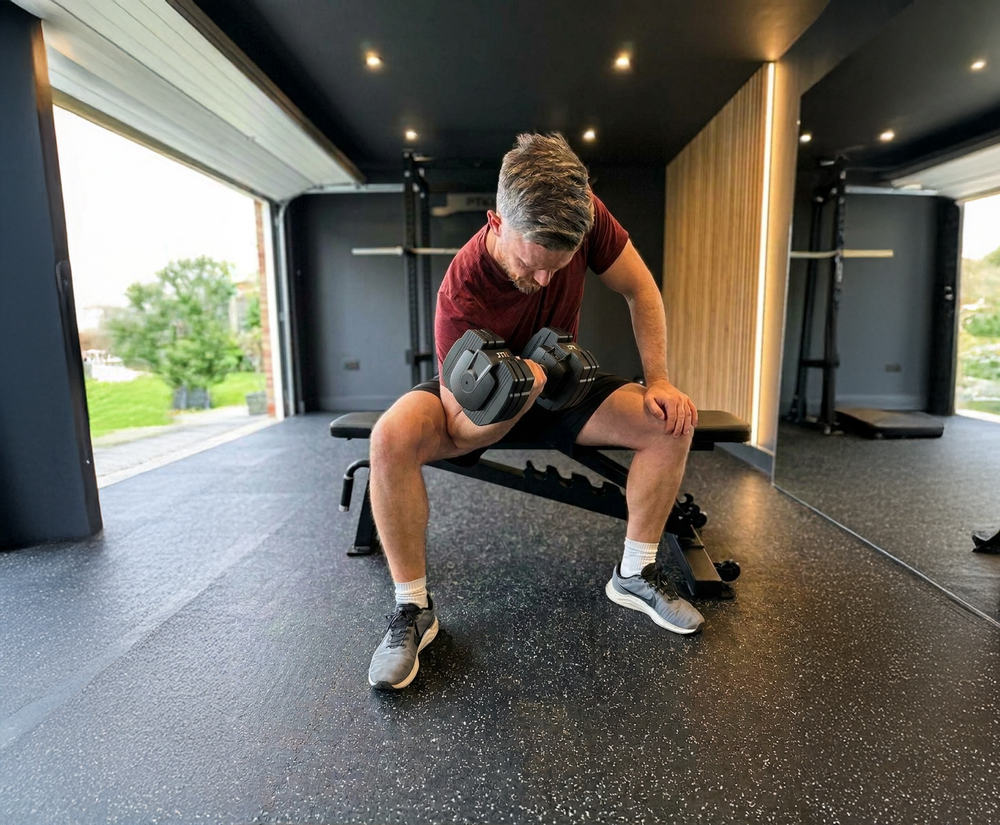 Man Doing a Seated Dumbbell Curl with 14kg Adjustable Dumbbells