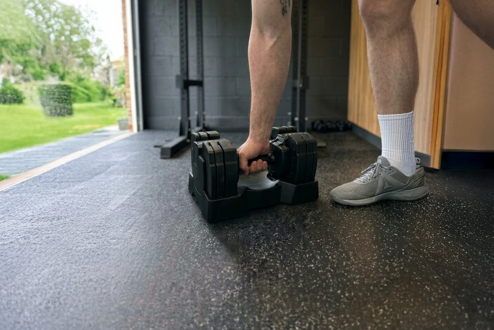 Man Picking Up The JTX 14kg Adjustable Dumbbell