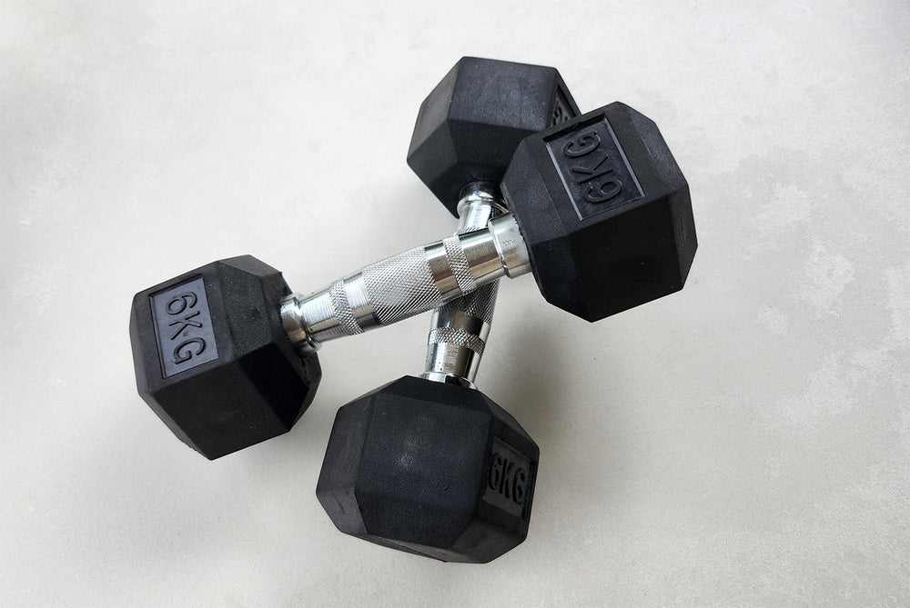 Pair of black hex dumbbells on a light grey background.