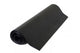 Rolled up black exercise mat on a white background.