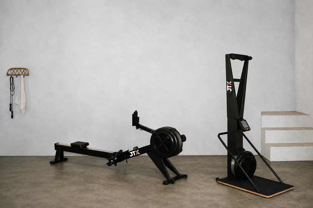 A ski machine and air rowing machine in a home gym setting.