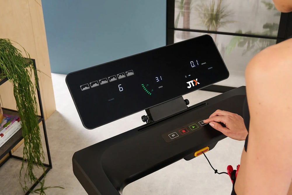 Person using the digital display on a JTX SlimLine treadmill. It shows calories, speed and distance.