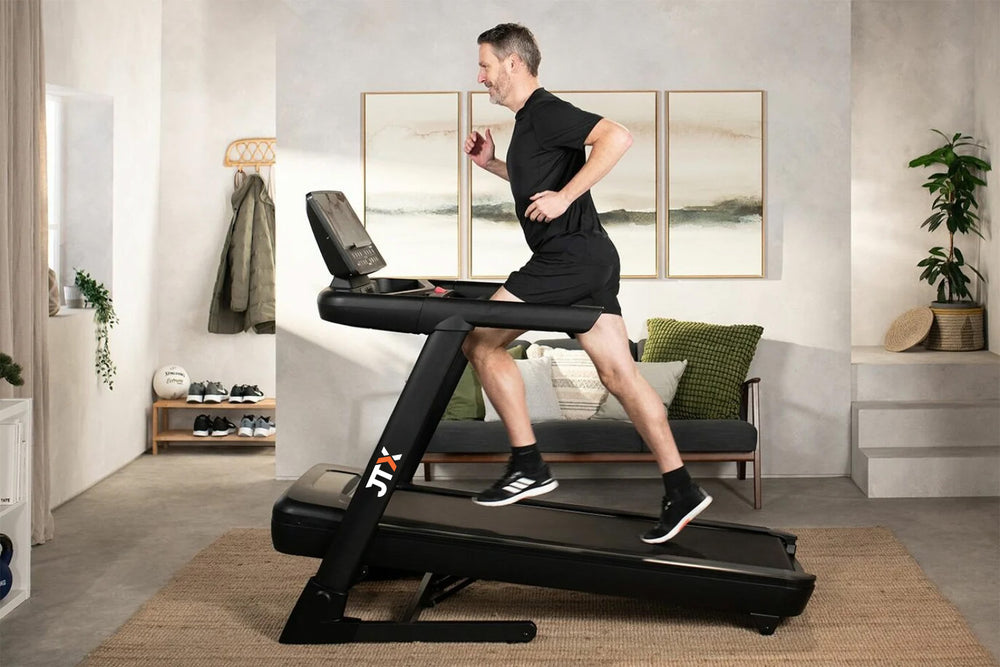 Man running on a JTX Sprint-8 treadmill set at an incline.