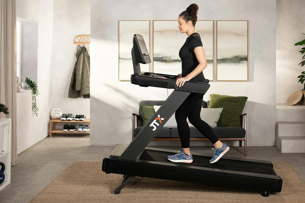Woman using a treadmill in a modern living room
