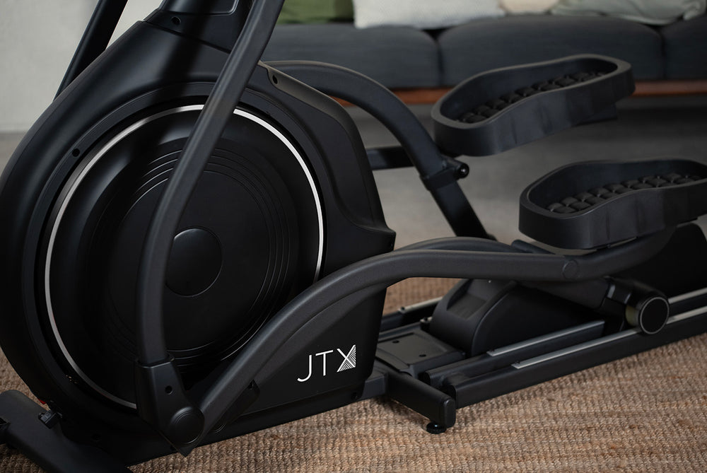 Front flywheel and footplates of the JTX Zenith Rise cross trainer.