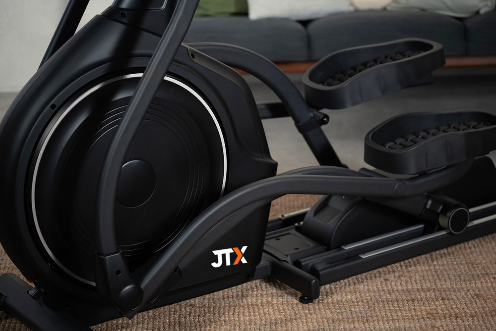 Front flywheel and footplates of the JTX Zenith Rise cross trainer.