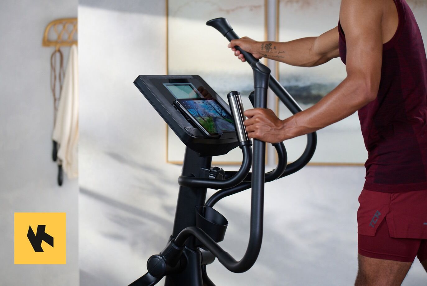 Man using JTX folding cross trainer with app connectivity
